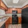 Spacious and well lit kitchen with wood flooring and stainless steel appliances
