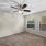 Large well lit bedroom with plush carpets and large windows 